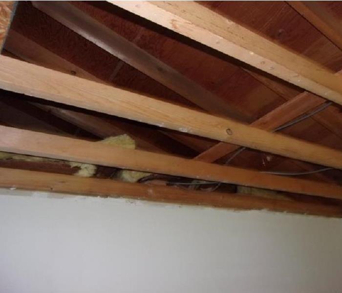 ceiling with drywall removed and joists exposed
